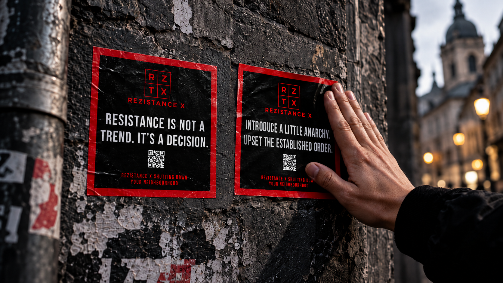 A person placing Rezistance stickers on a city wall